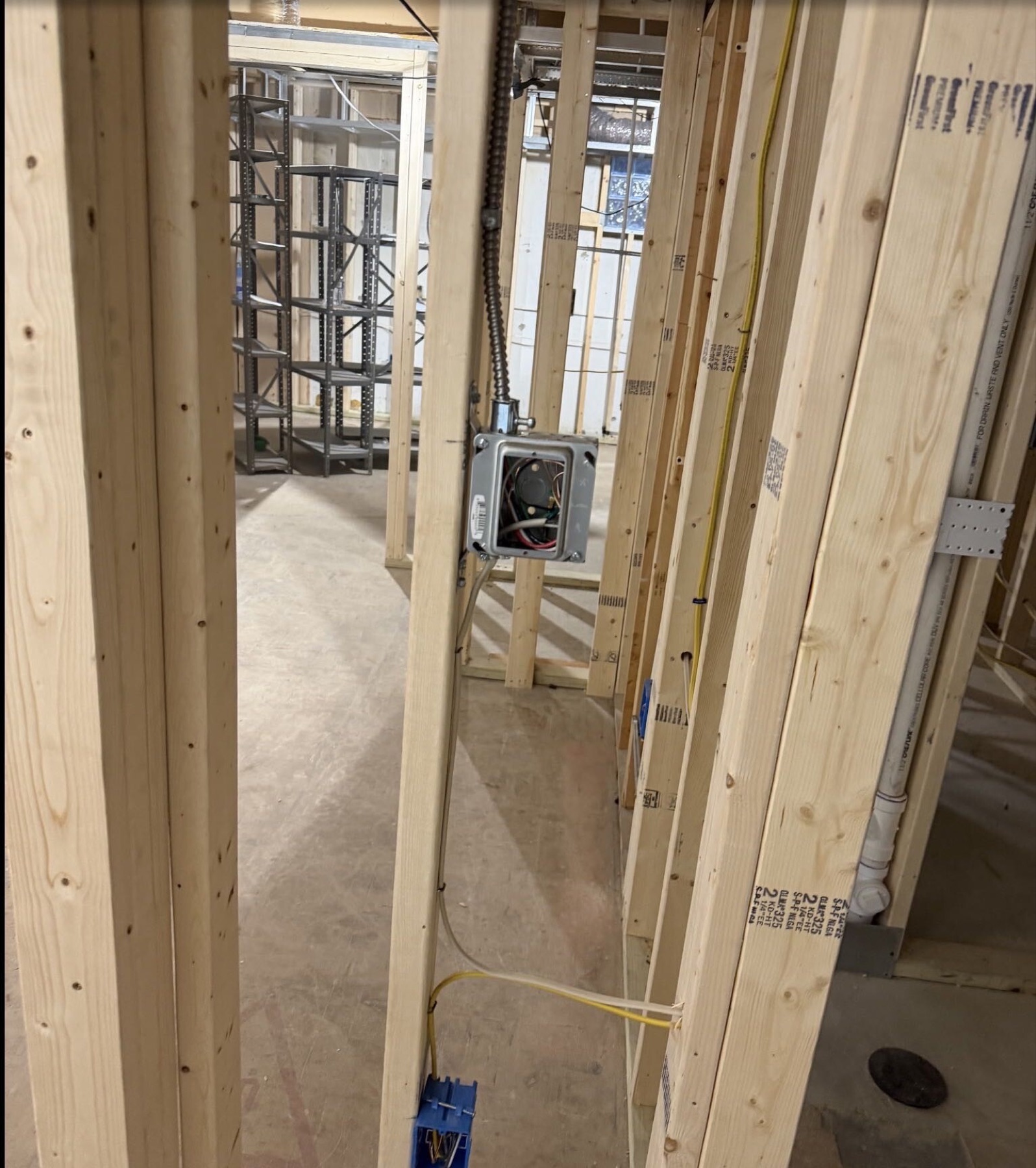 Framed lower-level room with exposed ceiling
